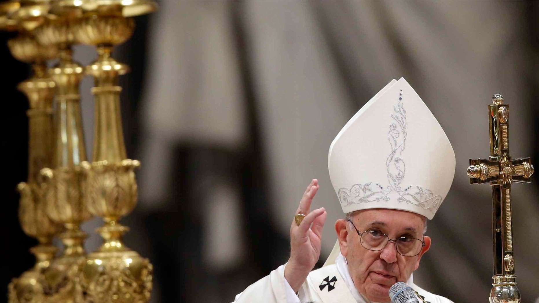 Pope Francis delivers a blessing at the end of a New Year mass in St. Peter's Basilica Jan. 1, 2016.