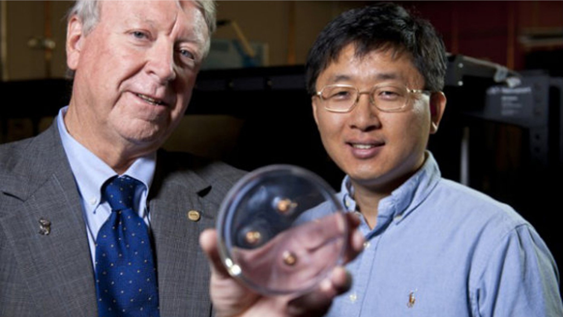 Rice University scientists Ned Thomas (left) and Jae-Hwang Lee with the material that stopped three bullets.