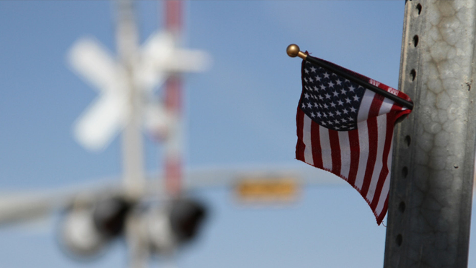 Nov. 17, 2012: A flag is left at the scene of an accident where four veterans were killed and 16 other people were injured when a train slammed into a parade float carrying the returning heroes to a banquet last Thursday in Midland, Texas.