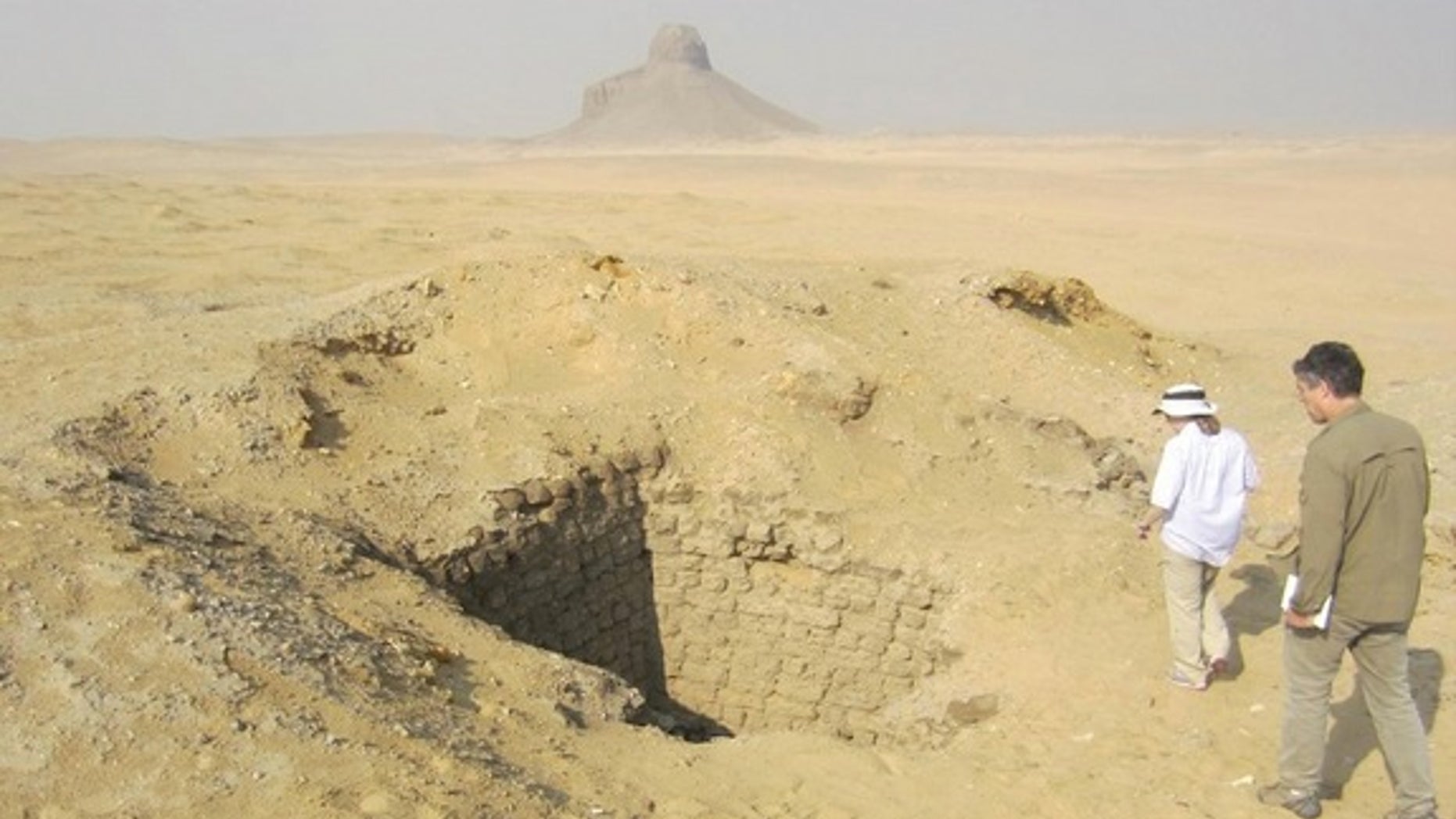Months after seeing evidence of looting from space, Parcak and her colleagues went to look at the looting pits in Dahshur for themselves. This one was 10 meters (33 feet) deep.
