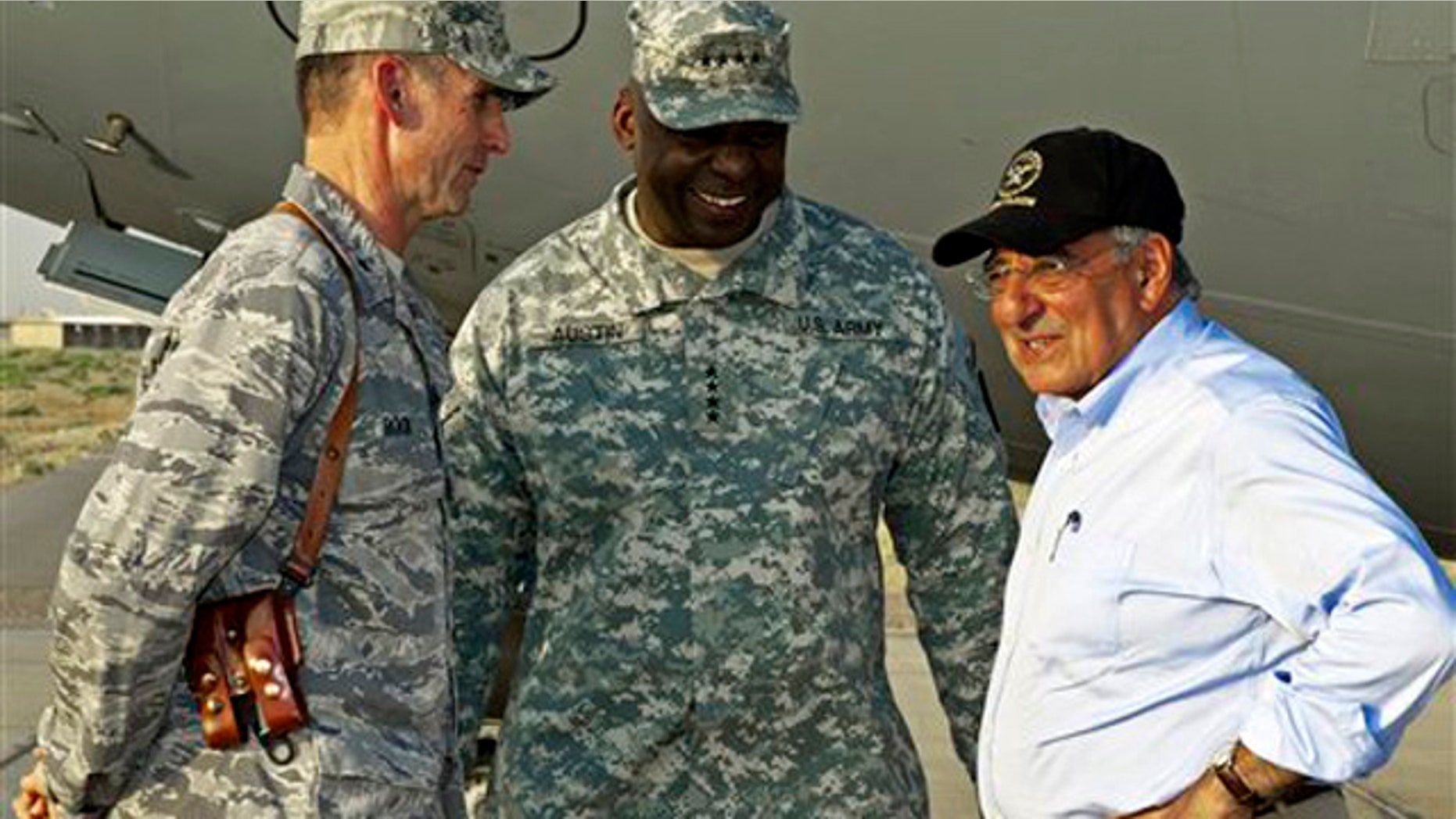 US Secretary of Defense Leon Panetta, right, has a brief chat with his US Generals Anthony Rock, left, and Lloyd Austin, late Sunday July 10, 2011, during an unannounced visit by the U.S. Secretary to Camp Dwyer, Sunday July 10, 2011, in southern Afghanistan. (AP Photo/Paul J. Richards, Pool)
