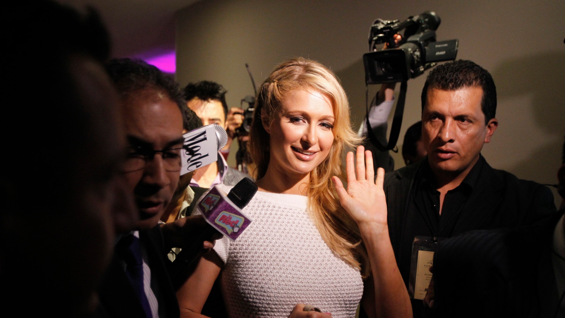 U.S. socialite Paris Hilton waves after a news conference during the launch of her latest store in Bogota, April 24, 2013.