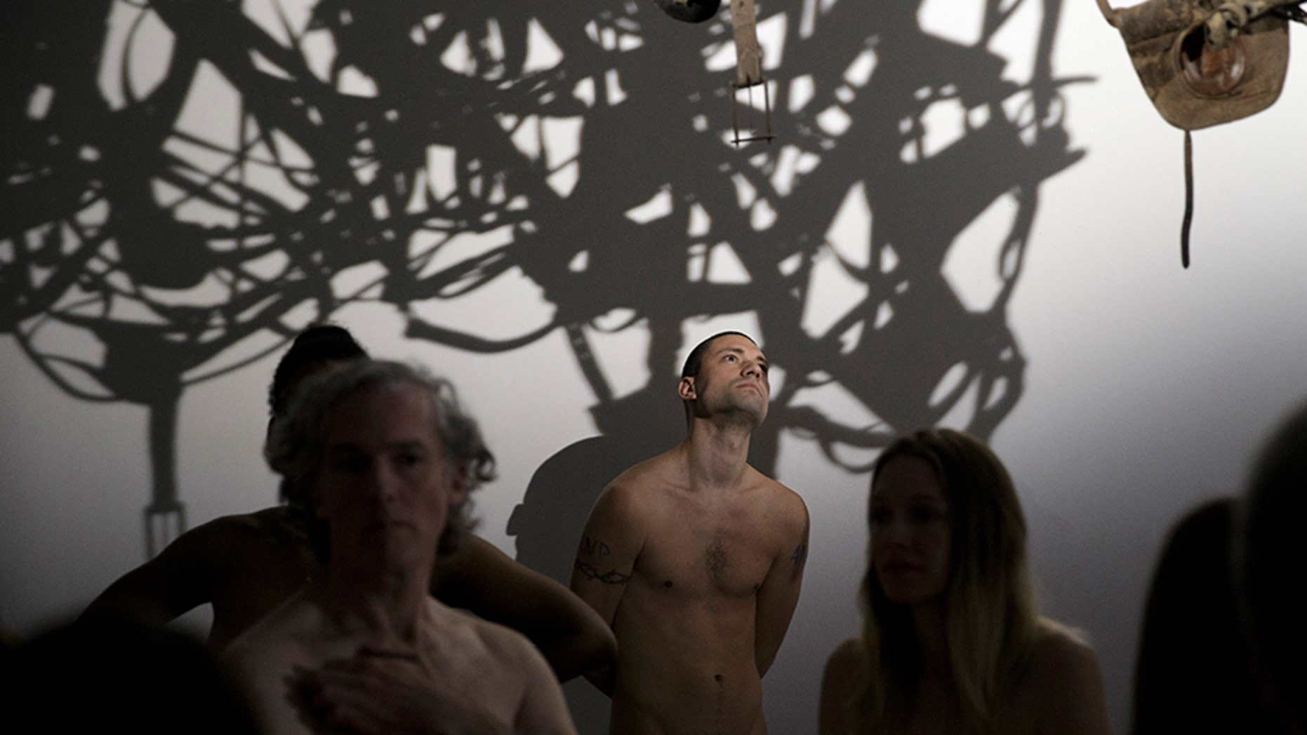 Members of the ANC (Association des Naturistes de Paris) taking part in a nude visit of the 'Discorde, Fille de la Nuit' season exhibition at the Palais de Tokyo contemporary art centre in Paris.