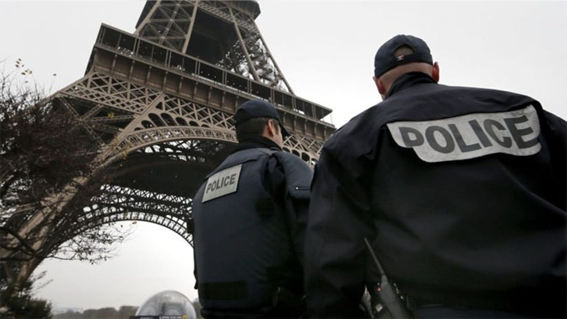French police patrol near the Eiffel Tower in Paris after a shooting at the Paris offices of Charlie Hebdo.