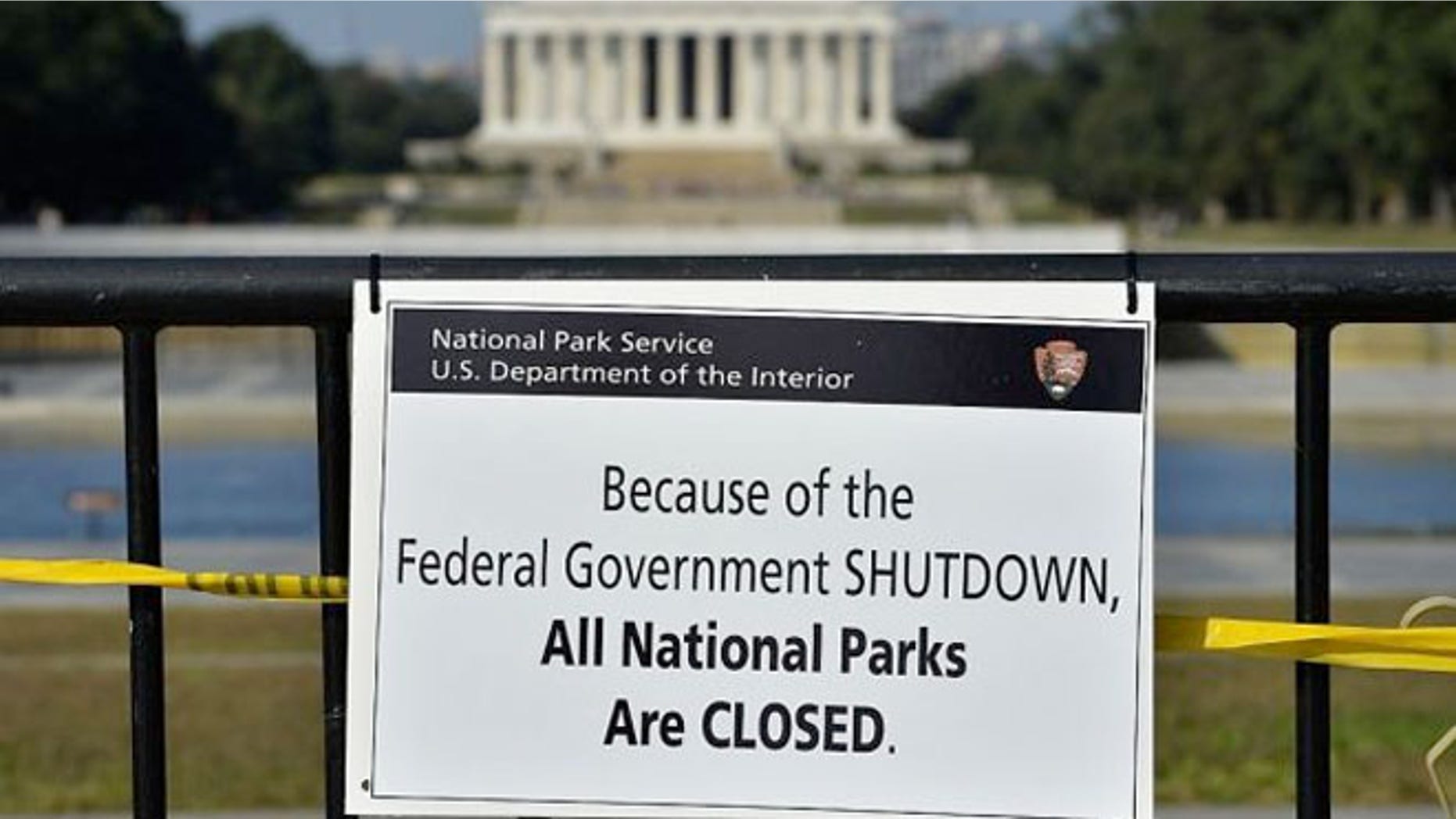 A National Park Service employee posted a sign on a barricade to close the Lincoln Memorial.