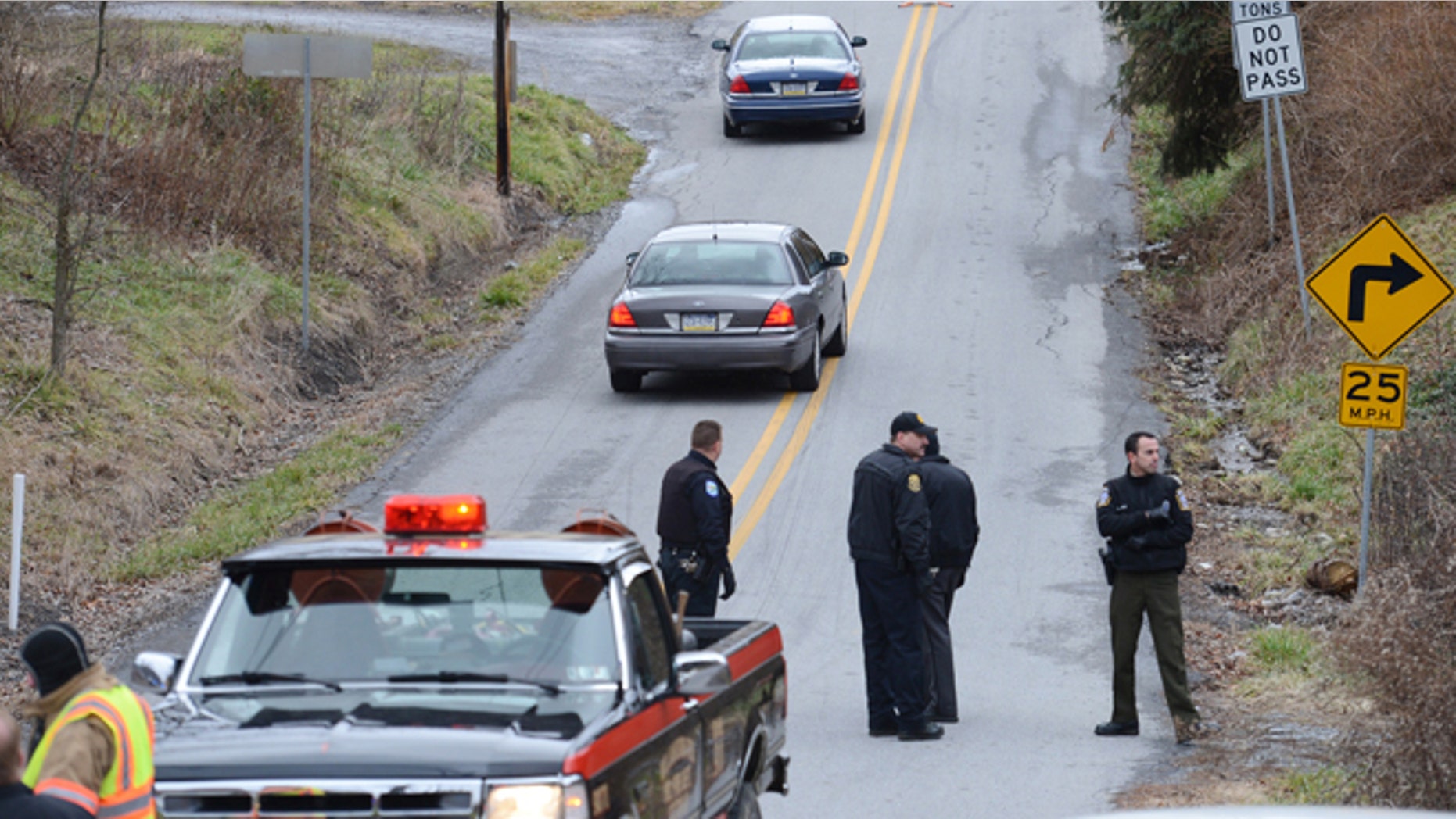 Dec. 21, 2012: Local law enforcement block off road along Rt. 22 near the Canoe Creek State Park, Pa. while investigating a shooting.