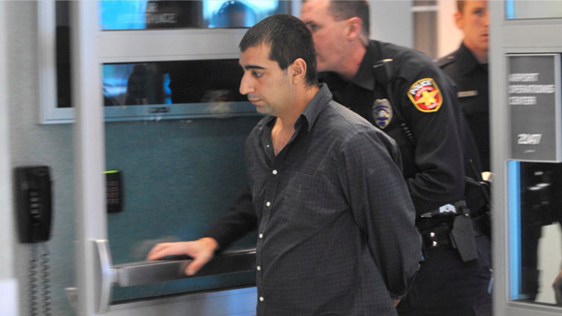 Oct. 28, 2011: Ali Reza Shahsavari, 29, of Indialantic, Fla., is escorted by Amarillo Police and FBI officers after causing a disturbance on a Southwest Airlines flight from Los Angeles to Kansas City.