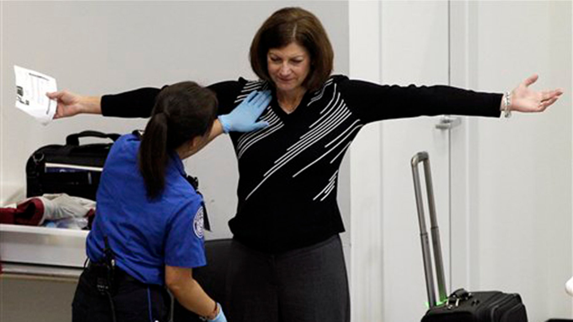 A woman undergoes a pat-down during TSA security screening, Friday, Nov. 19, 2010, at Seattle-Tacoma International Airport in Seattle.