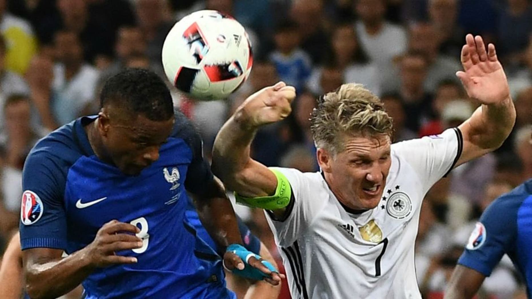 Germany's midfielder Bastian Schweinsteiger (R) touches the ball with his hand as he jumps with France's defender Patrice Evra (L), leading to a penalty for France, during the Euro 2016 semi-final football match between Germany and France at the Stade Velodrome in Marseille on July 7, 2016. / AFP / ANNE-CHRISTINE POUJOULAT (Photo credit should read ANNE-CHRISTINE POUJOULAT/AFP/Getty Images)