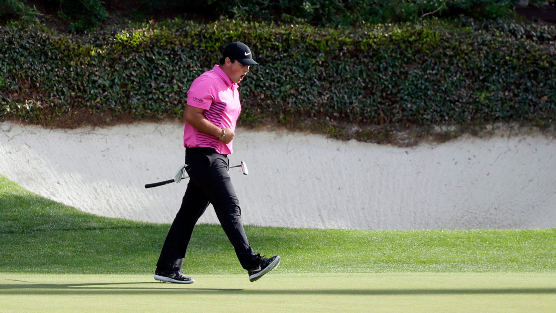 Patrick Reed reacts after making birdie at the 12th hole at the Masters Sunday.