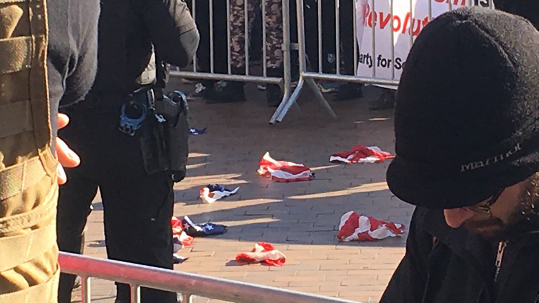 Torn pieces of an American flag lie on the ground at the University of Washington, Feb. 10, 2018.
