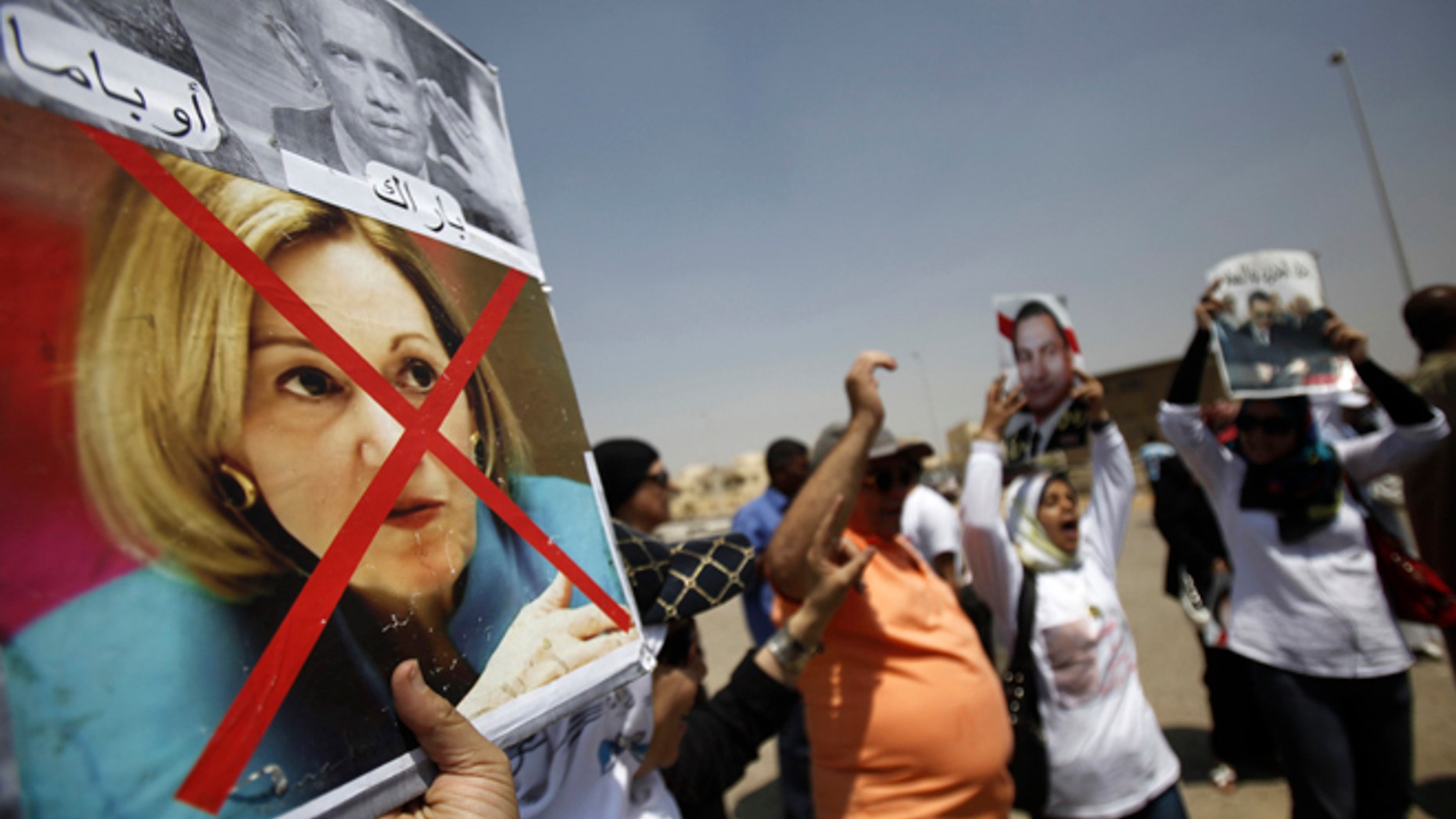 A defaced picture of ex-U.S. Ambassador to Egypt Anne Patterson is seen in this poster held by a supporter of Egypt's former president Hosni Mubarak in 2013.