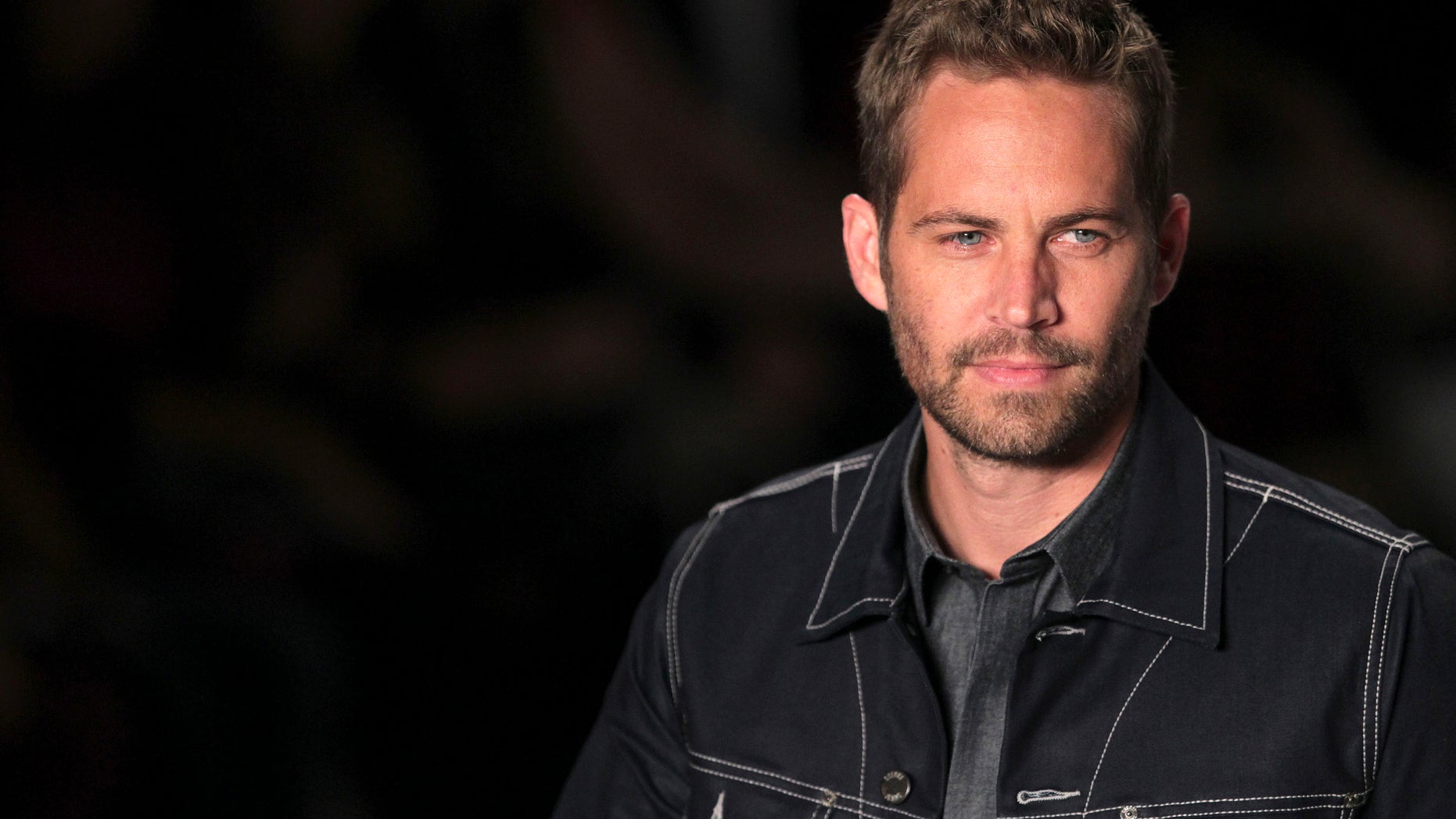 March 21, 2013. Paul Walker presents a creation from Colcci's 2013/2014 summer collection during Sao Paulo Fashion Week.