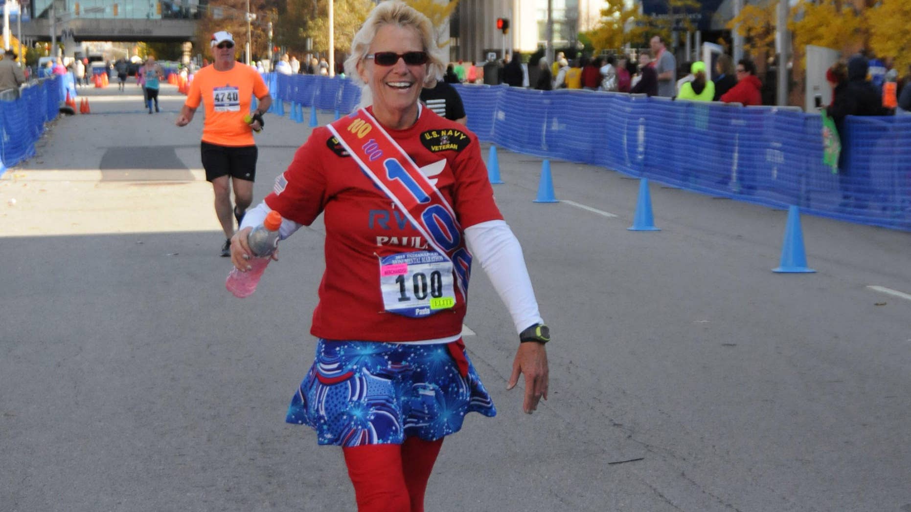 Paula Steinbach is recognized at the finish of the Monumental Marathon in Indianapolis, her 100th race at the distance.