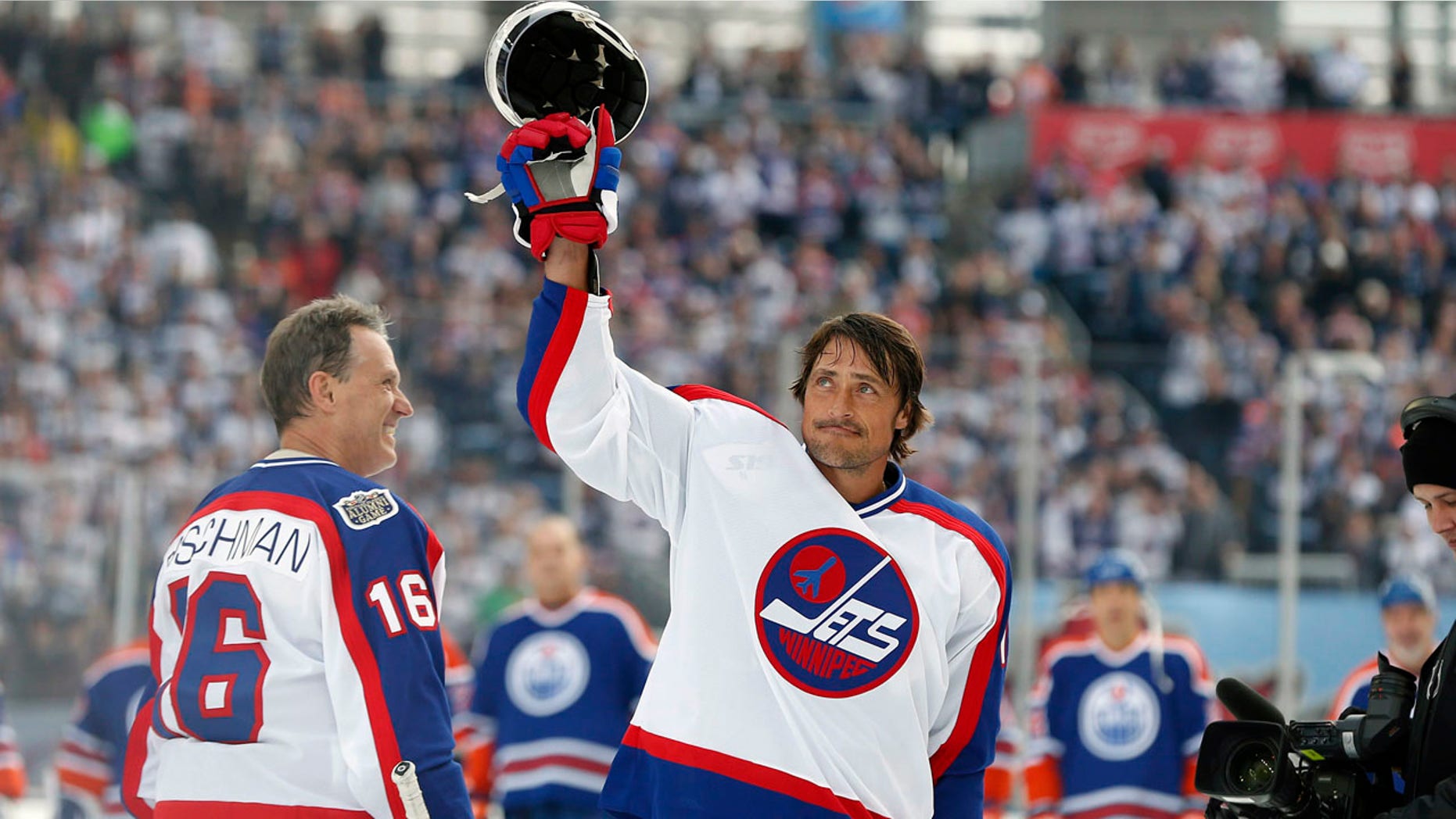 FILE - In this Oct. 22, 2016, file photo, former Winnipeg Jets player Teemu Selanne (13) waves to the crowd at Investors Group Field prior to the NHL Heritage Classic Alumni hockey game in Winnipeg, Manitoba. Selanne is expected to headline the Hockey Hall of Fame's induction class of 2017, when it is announced Monday, June 26, 2017. (John Woods/The Canadian Press via AP, File)