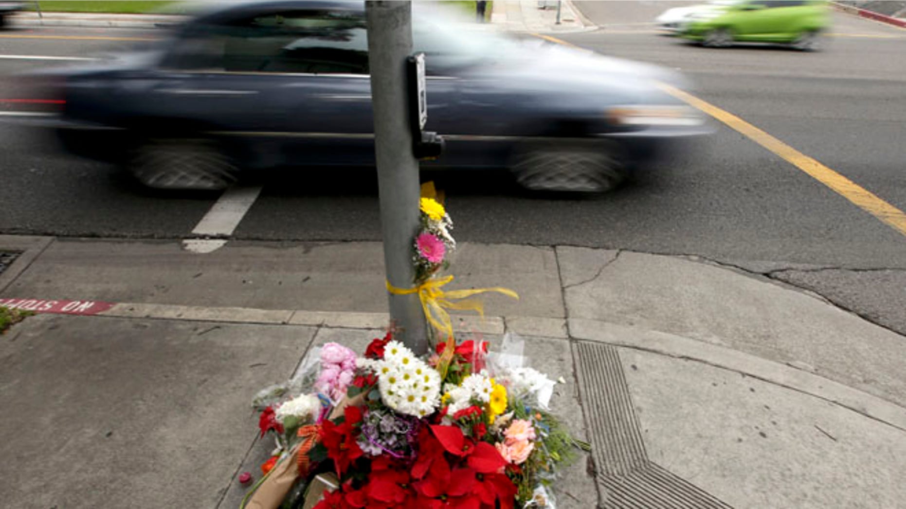 Dec. 18, 2014: Mourners placed flowers at a make shift memorial near where a driver suspected of being intoxicated hit a group of pedestrians and another car outside a church as a Christmas service ended Wednesday night in Redondo Beach, Calif. (AP)