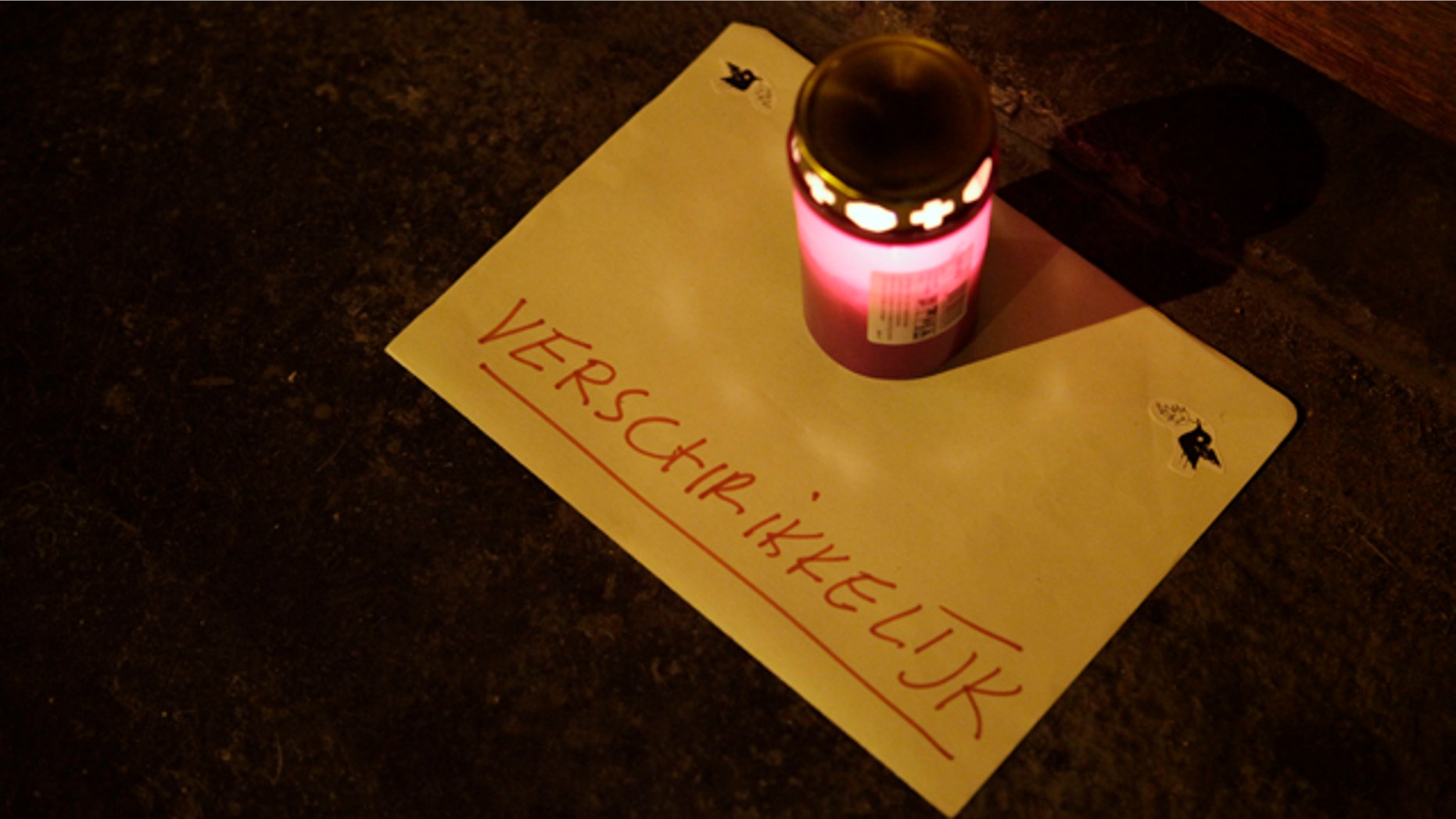 Dec. 12: A lone candle with a note reading "horrible" sits in the doorway of a daycare center in Amsterdam, where a man suspected of abusing preschool children was employed. Parents of dozens of preschool children in Amsterdam have been warned their children may have been abused by a baby sitter in one of the worst sexual abuse cases to come to light in the Netherlands. (AP)