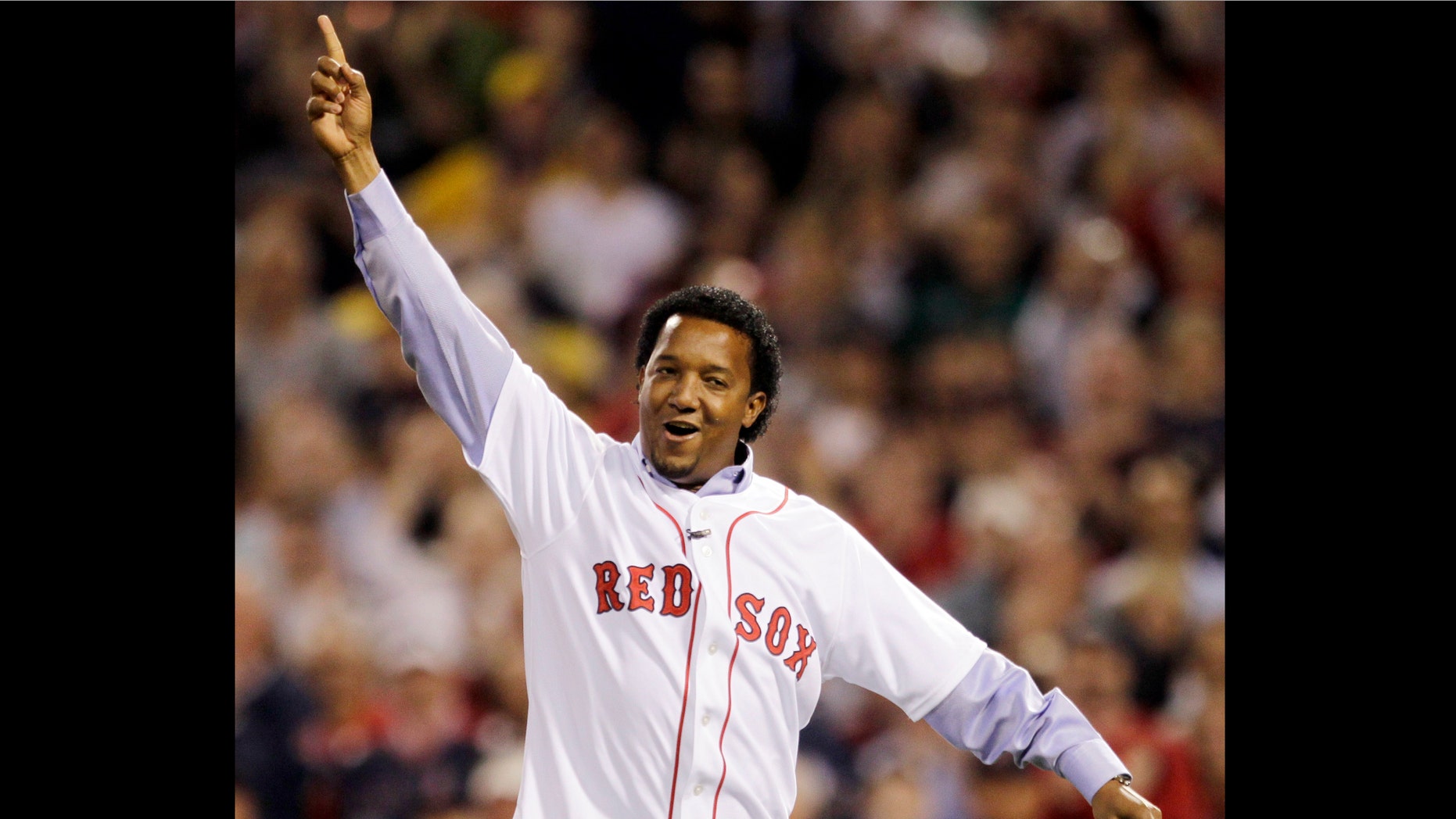 FILE - In this April 4, 2010, file photo, former Boston Red Sox pitcher Pedro Martinez reacts after throwing the ceremonial first pitch before the Red Sox opening game of the baseball season against the New York Yankees in Boston. Martinez, a three-time Cy Young Award winner and eight-time All-Star, who spent seven seasons in Boston, was brought back to the franchise to serve as a special assistant to general manager Ben Cherington, the team announced, Thursday, Jan. 24, 2013. (AP Photo/Charles Krupa, File)