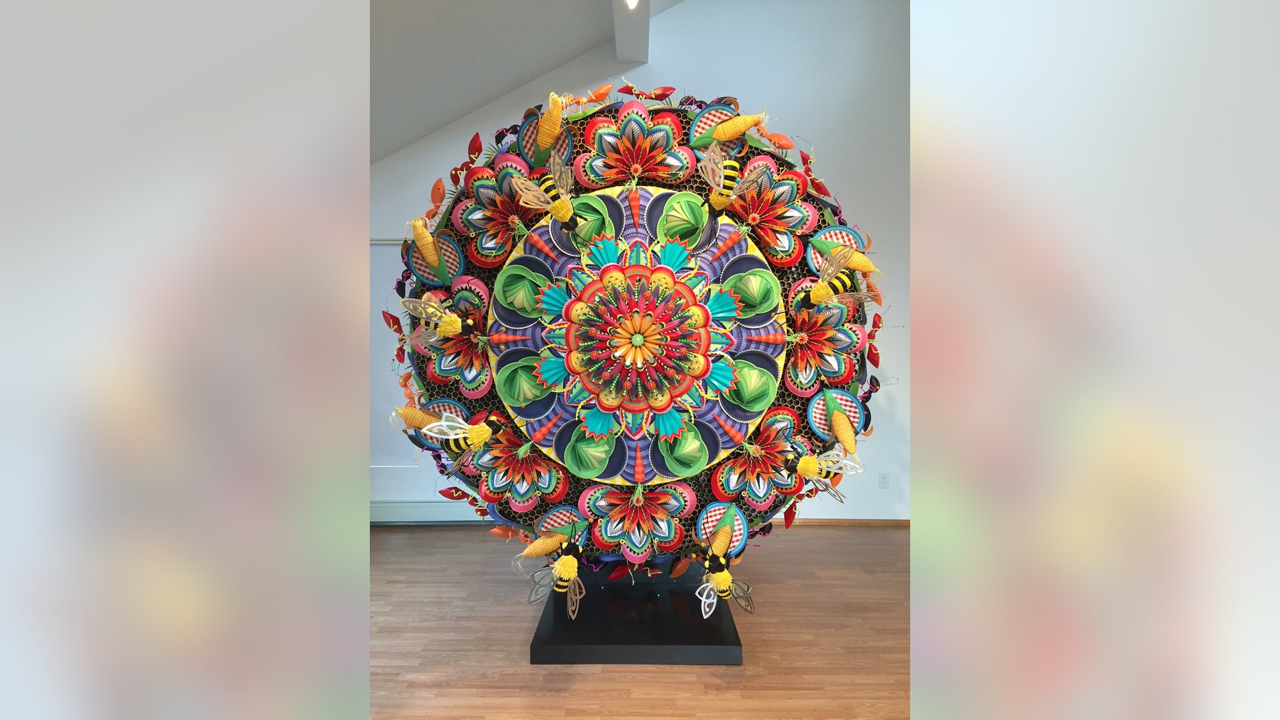 This undated photo provided by the American Visionary Art Museum in Baltimore shows "Brackman's Botanical Bonanza!" by Wendy Brackman. The work, made from paper plates, straws, balls, paper towel tubes and staples, is part of the museum's "YUMMM! The History, Fantasy, and Future of Food," exhibition. (Jill Ribich/AVAM via AP)