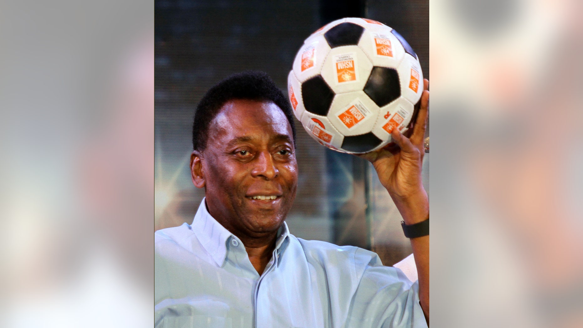FILE - In this Oct. 12, 2015 file photo, Brazilian football legend Pele poses with a football during an interaction session with students in Kolkata, India. (AP Photo/Bikas Das File)