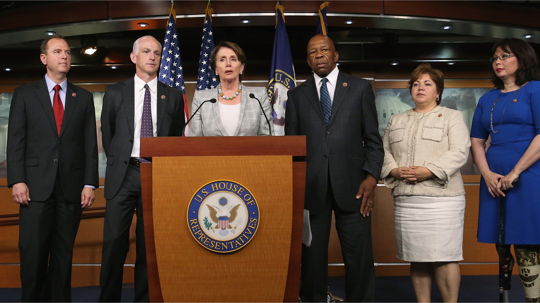 WASHINGTON, DC - MAY 21: Minority Leader Nancy Pelosi (D-CA) (C) speaks while flanked by five fellow Democrats (L-R) Rep. Rep. Adam B. Schiff (D-CA), Rep. Adam Smith (D-WA), Rep. Elijah E. Cummings (D-MD), Rep. Linda Sanchez, (D-CA) and Rep. Tammy Duckworth (D-IL) during a news conference on Capitol Hill, May 21, 2014 in Washington, DC. Leader Pelosi named the five Democrats to serve on the special committee looking into the 2012 attack in Benghazi, Libya. (Photo by Mark Wilson/Getty Images,)
