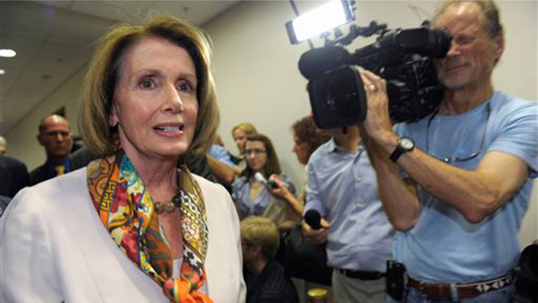 House Minority Leader Nancy Pelosi walks past reporters as she heads to a Democratic caucus meeting on Capitol Hill in Washington Aug. 1.