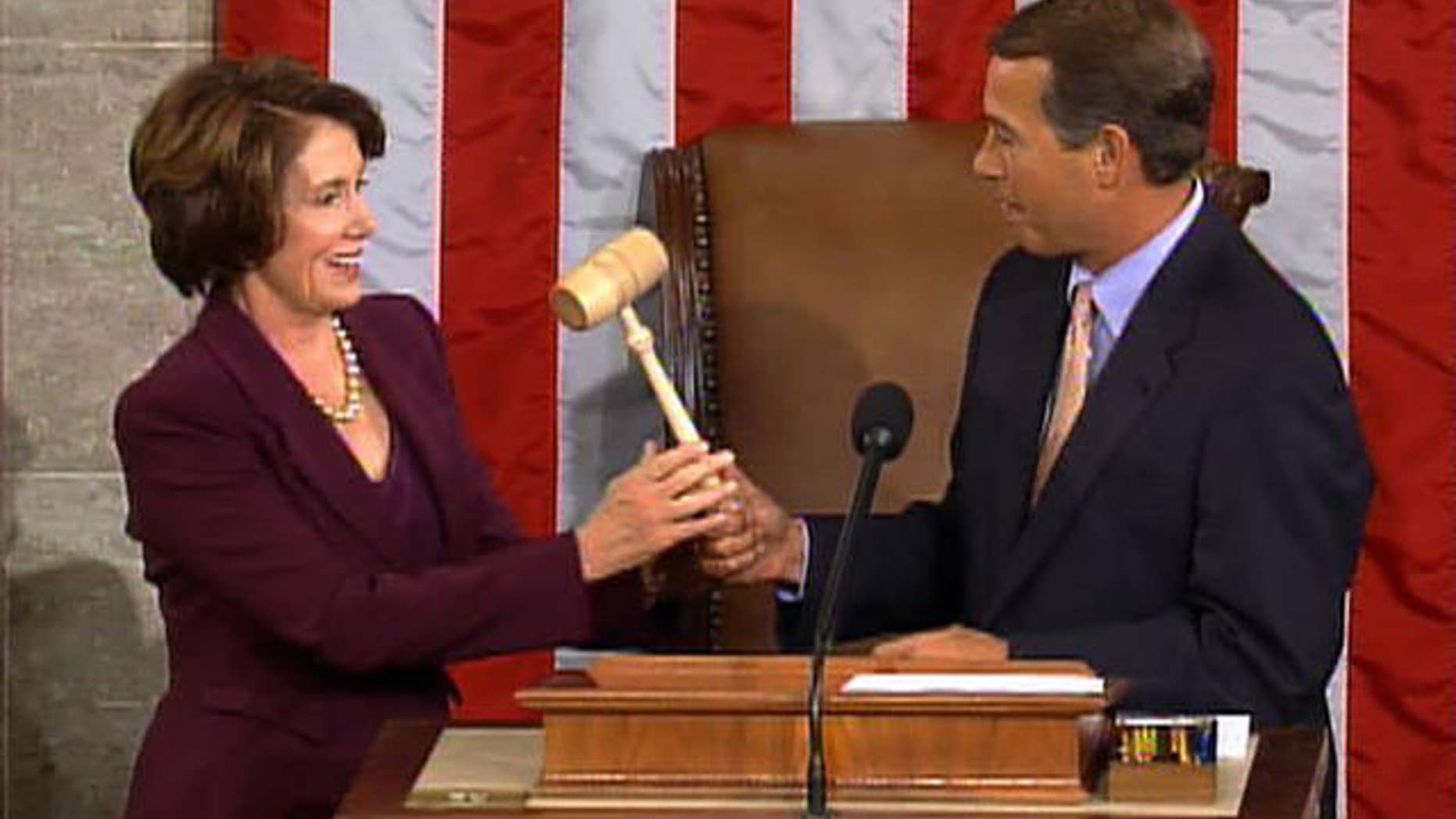 FILE: In this Jan. 4, 2007, photo, Minority Leader John Boehner hands the gavel to newly sworn-in Speaker Nancy Pelosi. A reversal of the two leaders' roles was happening Wednesday.