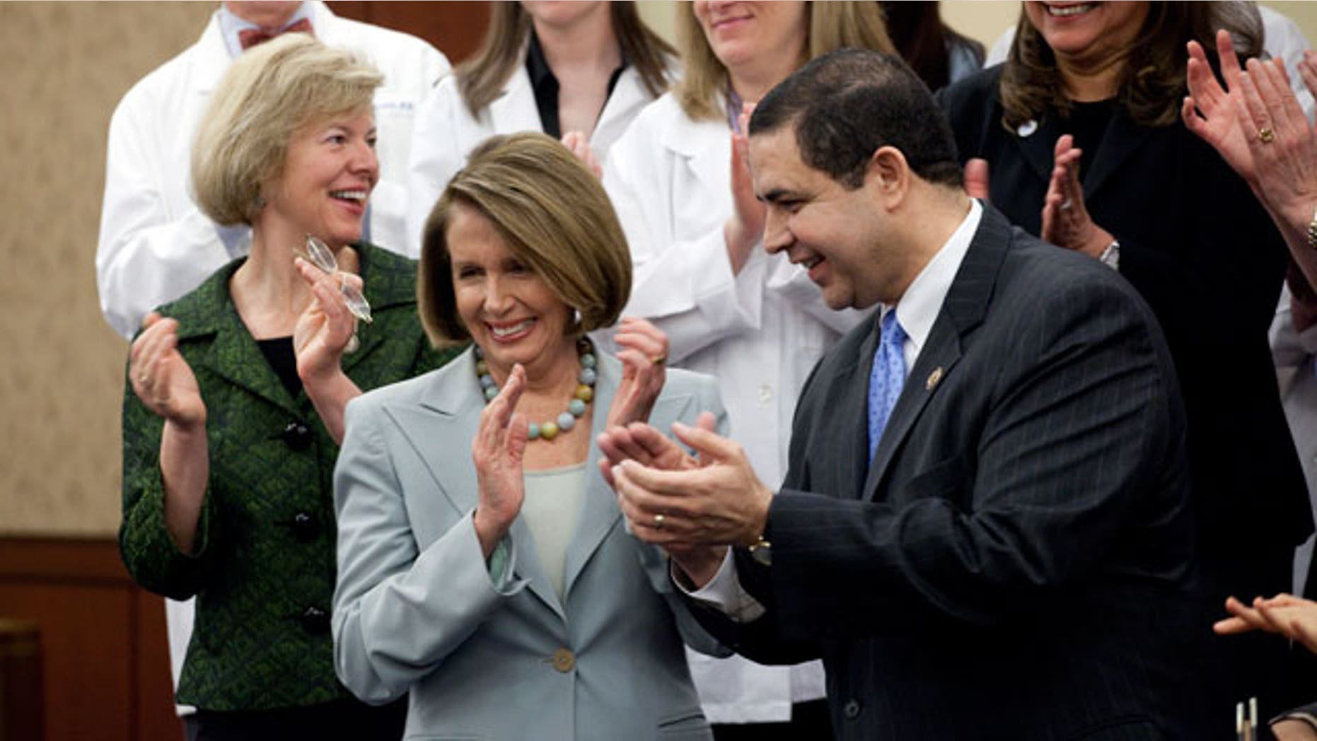 Rep. Tammy Baldwin, D-Wisc., Democratic Minority Leader, Nancy Pelosi, D-Calif., and Rep. Henry Cuellar, D-Tex., at a ceremony marking the one year anniversary of the passage of the Health Care Act on Capitol Hill in Washington on Thursday, March 17, 2011. (AP)