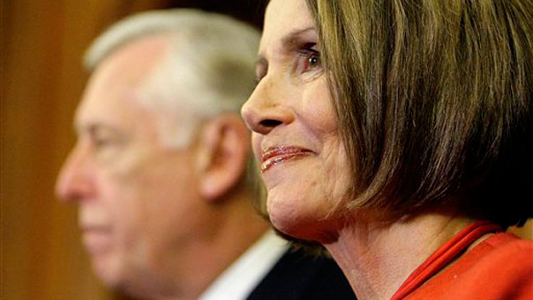 Speaker Nancy Pelosi smiles at a press conference at the U.S. Capitol Nov. 7, as House Majority Leader Steny Hoyer looks on. (AP Photo)