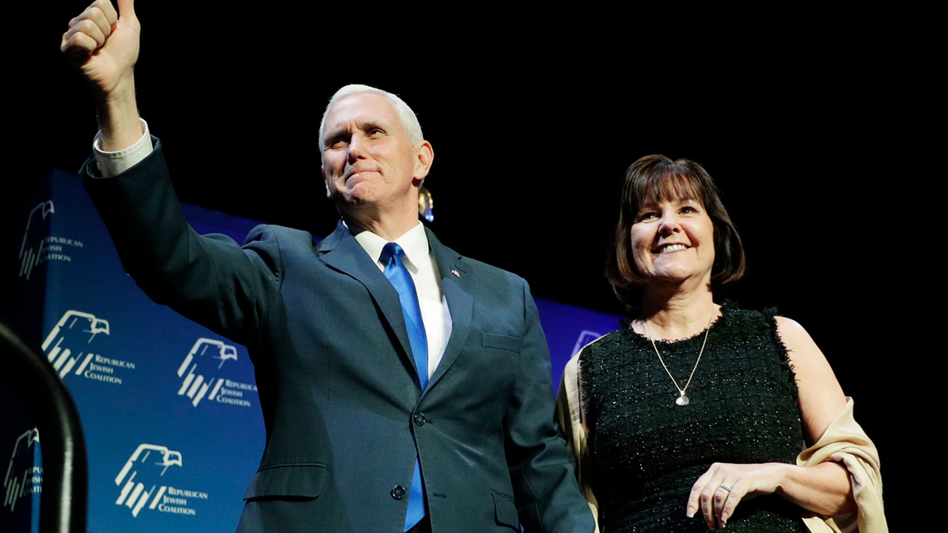 Vice President Mike Pence, left, takes the stage with his wife Karen Pence at the Republican Jewish Coalition annual leadership meeting, Friday, Feb. 24, 2017, in Las Vegas. (AP Photo/John Locher)