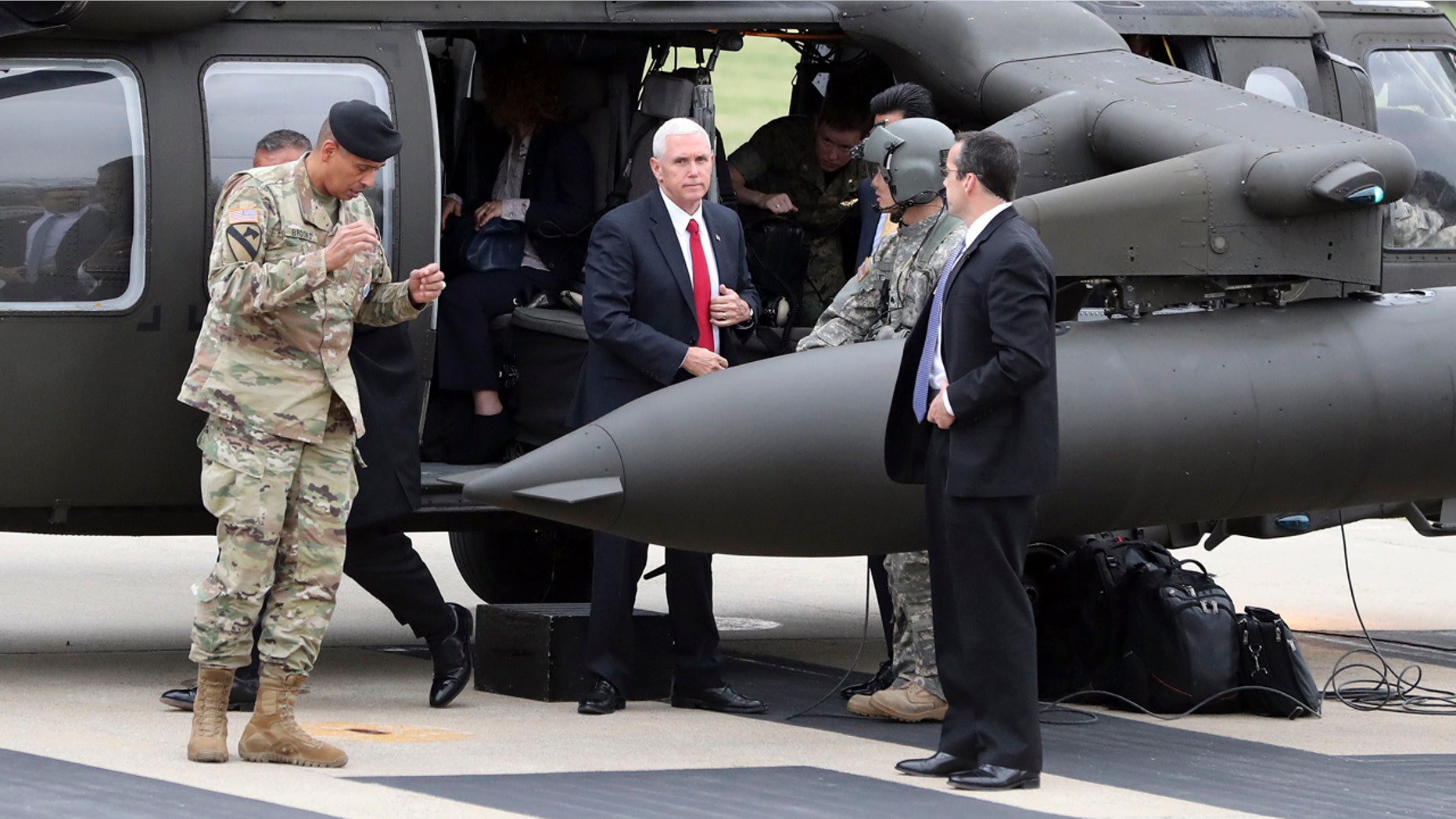 U.S. Vice President Mike Pence, center, arrives at Camp Bonifas outside of the Demilitarized Zone (DMZ), near the border village of Panmunjom, in Paju, South Korea, Monday, April 17, 2017. U.S. Vice President Pence visited a military base near the Demilitarized Zone separating North and South Korea a day after the North conducted a failed missile launch. (AP Photo/Lee Jin-man)