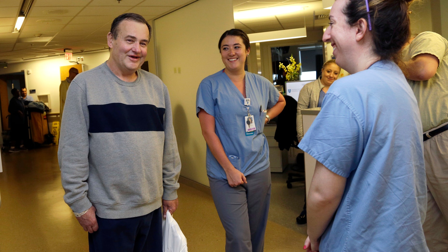Thomas Manning, of Halifax, Mass., chats with nurses, Caroline Pinnette, middle, and Ashley DiPaolo as he prepares to be discharged from Massachusetts General Hospital, Wednesday, June 1, 2016, in Boston. Manning is the first man in the United States to undergo a penis transplant. (AP Photo/Elise Amendola)