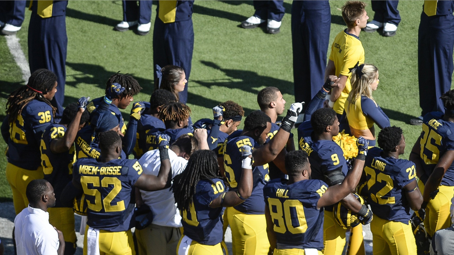 Sept. 24, 2016: Michigan football players raise their fists up in protest during the National Anthem, before an NCAA college football game against Penn State in Ann Arbor, Mich.