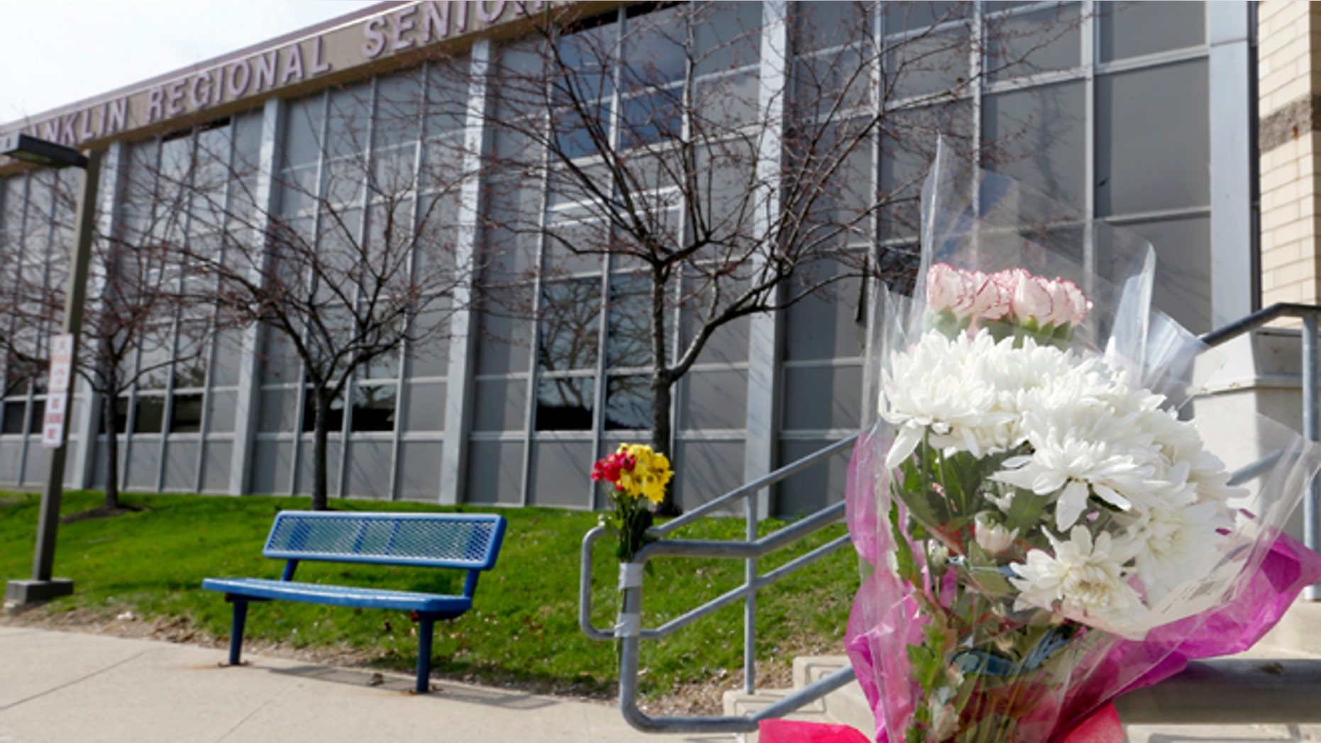 April 10, 2014: A bouquet of flowers is taped to a stairway rail near the entrance to Franklin Regional High School near Pittsburgh in Murrysville, Pa. A knife wielding student injured over 20 people in a stabbing attack there on April 9.