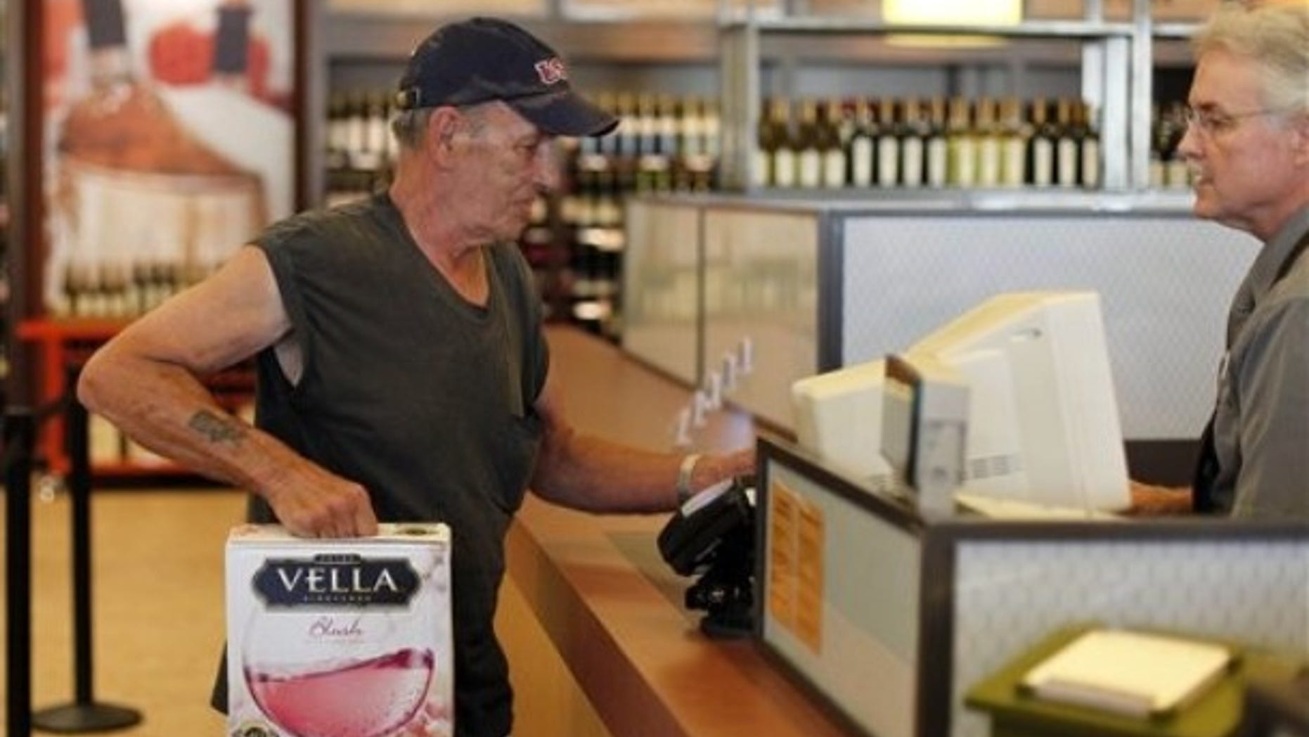 In this Thursday, July 22, 2010 photo, George Slack, left, of Lambertville N.J. makes the first purchase at a newly opened state wine and liquor store in New Hope Pa.