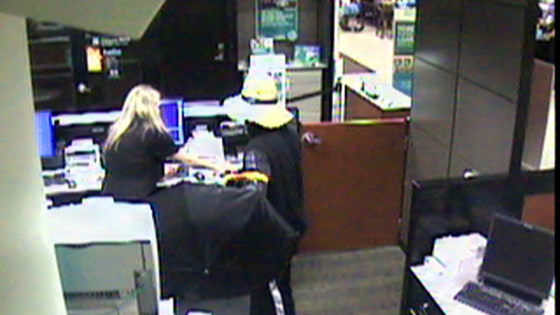 June 16, 2013: An image form a surveillance video released by the South Strabane Township Police shows a robbery, at the Citizens Bank inside the Giant Eagle at Strabane Square in South Strabane Township, Pa., by a man in a floppy hat. The suspect fatally shot a supermarket customer who ran after him and tried to stop his getaway car, police said.