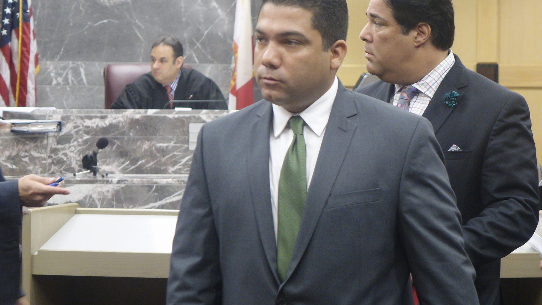 Broward Sheriff’s Deputy Peter Peraza, center, in December.