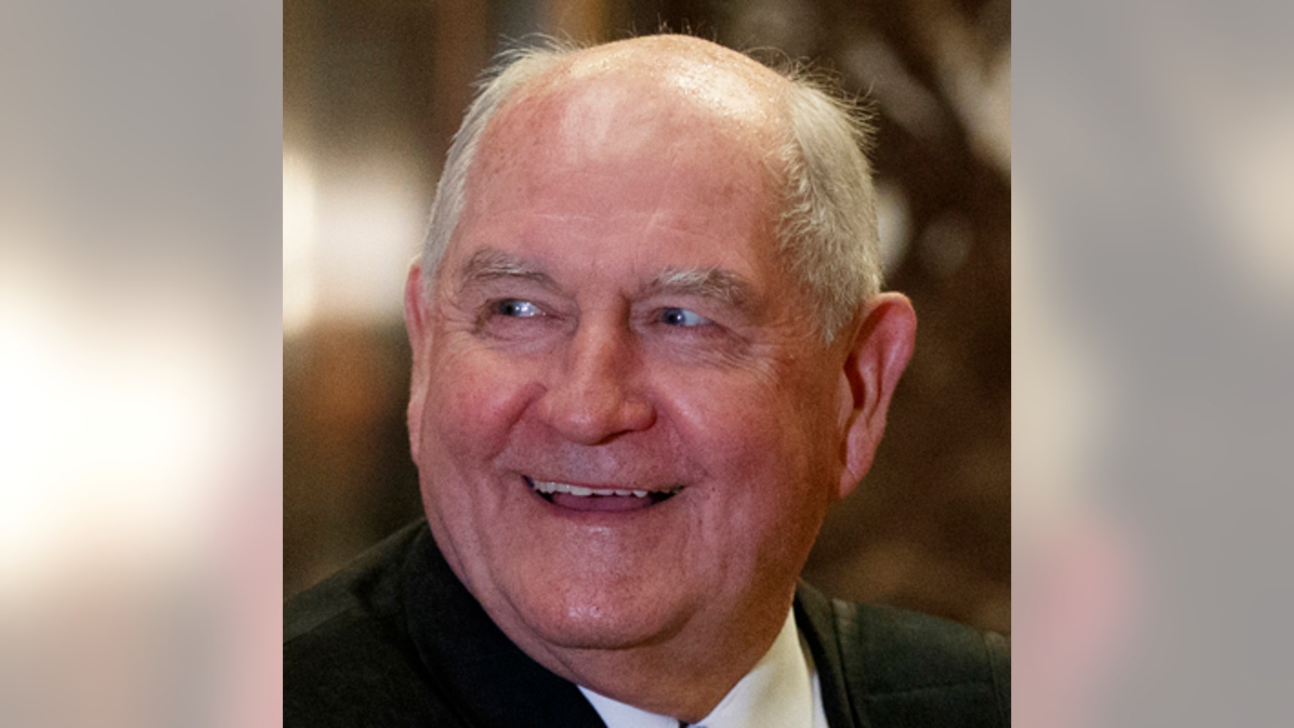 FILE- In this Nov. 30, 2016, file photo, former Georgia Gov. Sonny Perdue smiles as he waits for an elevator in the lobby of Trump Tower in New York. A person familiar with the decision says President-elect Donald Trump has chosen Perdue to serve as agriculture secretary. (AP Photo/Evan Vucci, File)