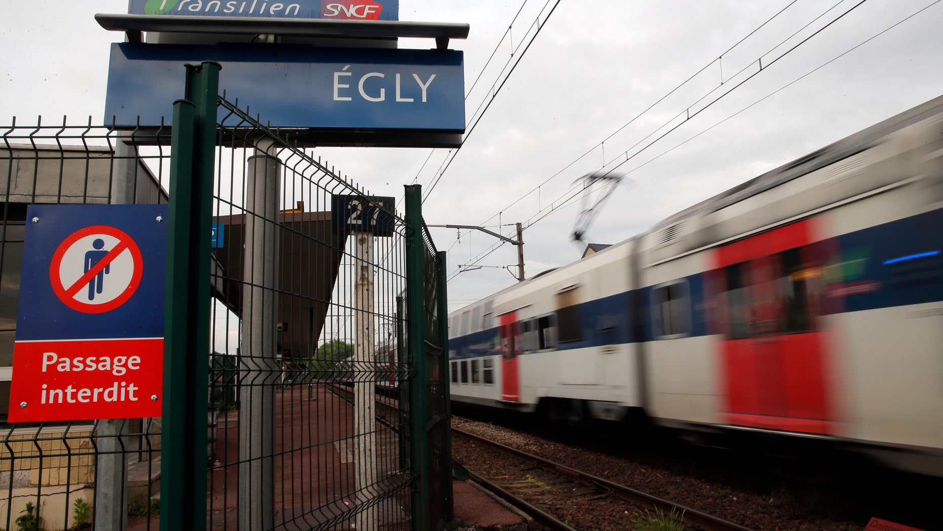 A train starts at the Egly station, south of Paris, Wednesday, May 11, 2016. French authorities opened an investigation Wednesday after a teenage woman allegedly live-streamed video of her suicide on the popular app Periscope. The local prosecutor said the young woman threw herself under a commuter train in the suburban Egly station, south of Paris. (AP Photo/Christophe Ena)