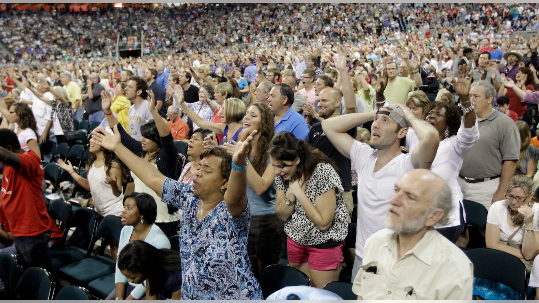 In this Aug. 6, 2011, file photo worshippers pray during The Response, a call to prayer for a nation in crisis in Houston.