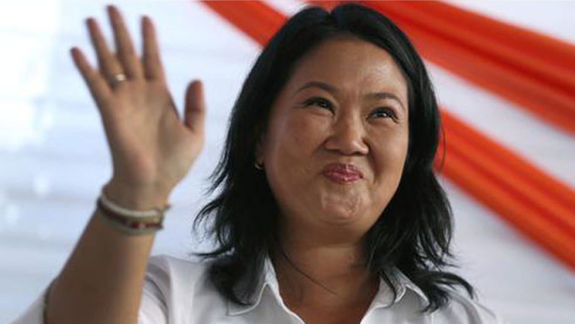 Presidential candidate Keiko Fujimori, center, of the "Fuerza Popular" political party, greets supporters as she campaigns in the San Juan de Lurigancho shantytown on the outskirts of Lima, Peru, Tuesday, May 10, 2016. On June 5, Keiko Fujimori will face Kuczynski in a runoff presidential election. (AP Photo/Martin Mejia)