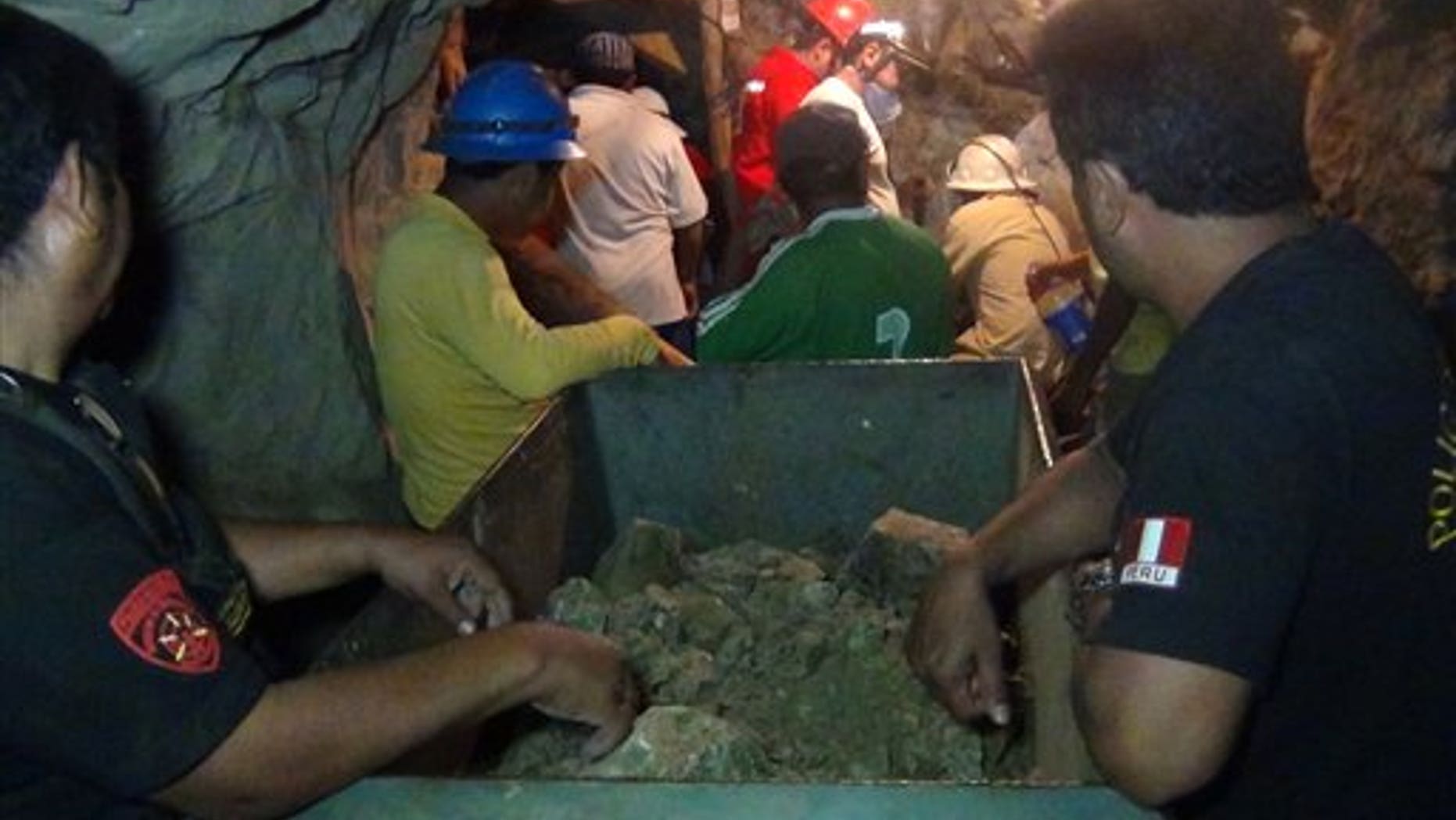 April 7, 2012: People work in a collapsed mine to rescue trapped miners in Ica, Peru. According to Peruvians authorities, nine miners trapped since Thursday in a collapsed mine are being supplied with sports drinks, soup and food while police, firefighters and other workers work to free them.