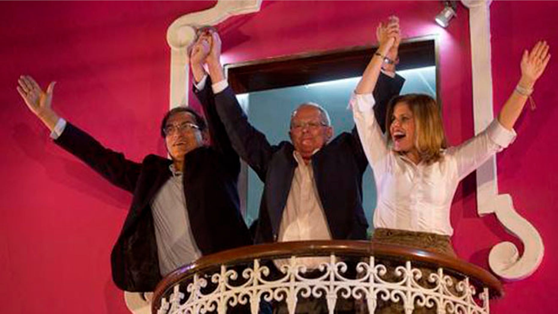 FILE - In this June 5, 2016 file photo, presidential candidate Pedro Pablo Kuczynski, center, celebrates with his running mates for first and second vice-presidents Martin Vizcarra, left, and Mercedes Araoz, right, from the balcony of their headquarters in Lima, Peru. Kuczynski began the task of forming a government Friday, June 10, 2016, after his rival Keiko Fujimori conceded defeat in Peru's closest presidential contest in five decades. His margin of victory was less than 43,000 votes, or 0.2 percentage points. (AP Photo/Rodrigo Abd, File)