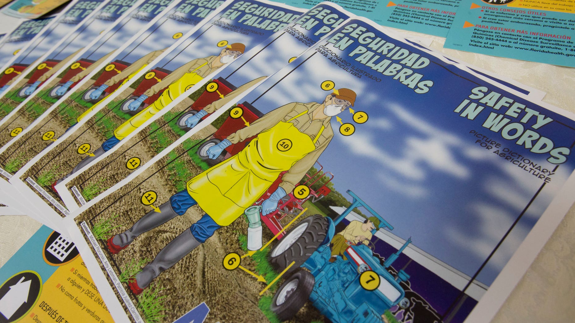 Safety pamphlets written in both English and Spanish are displayed during a pesticide safety training class for farm supervisors in Sebring, Fla. Millions of farm workers do jobs with a high risk of exposure to toxic chemicals every day, yet a federal system of protections meant to improve safety and provide an avenue for reporting exposure is ineffective and riddled with problems, according to an Associated Press review of federal and state enforcement data and case records. (AP Photo/Wilfredo Lee)