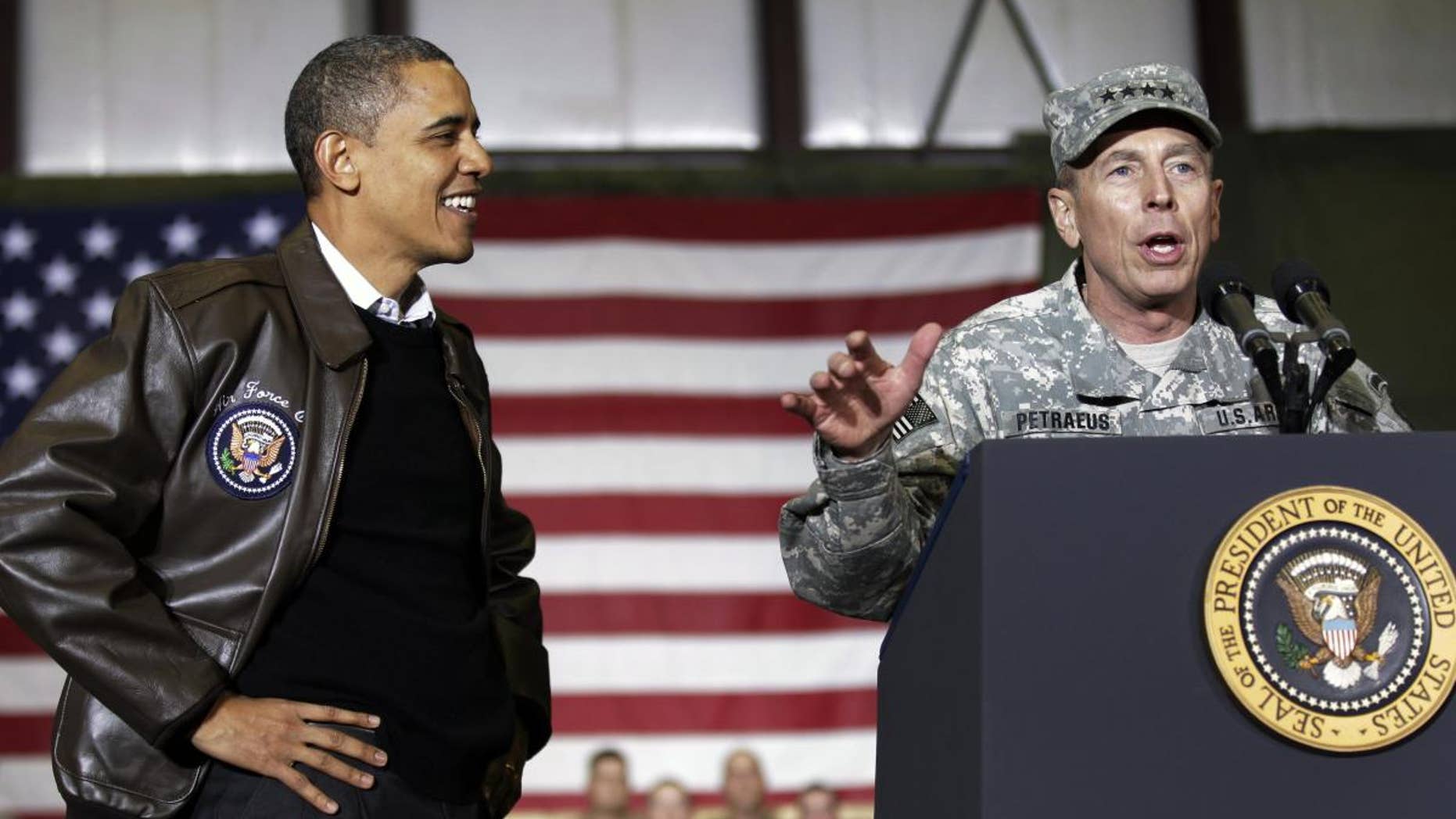President Barack Obama, left, is introduced NATO Commander in Afghanistan U.S. Gen David Petraeus, right, to the troops during a rally in an unannounced visit at Bagram Air Field in Afghanistan, Friday, Dec. 3, 2010.(AP Photo/Pablo Martinez Monsivais)