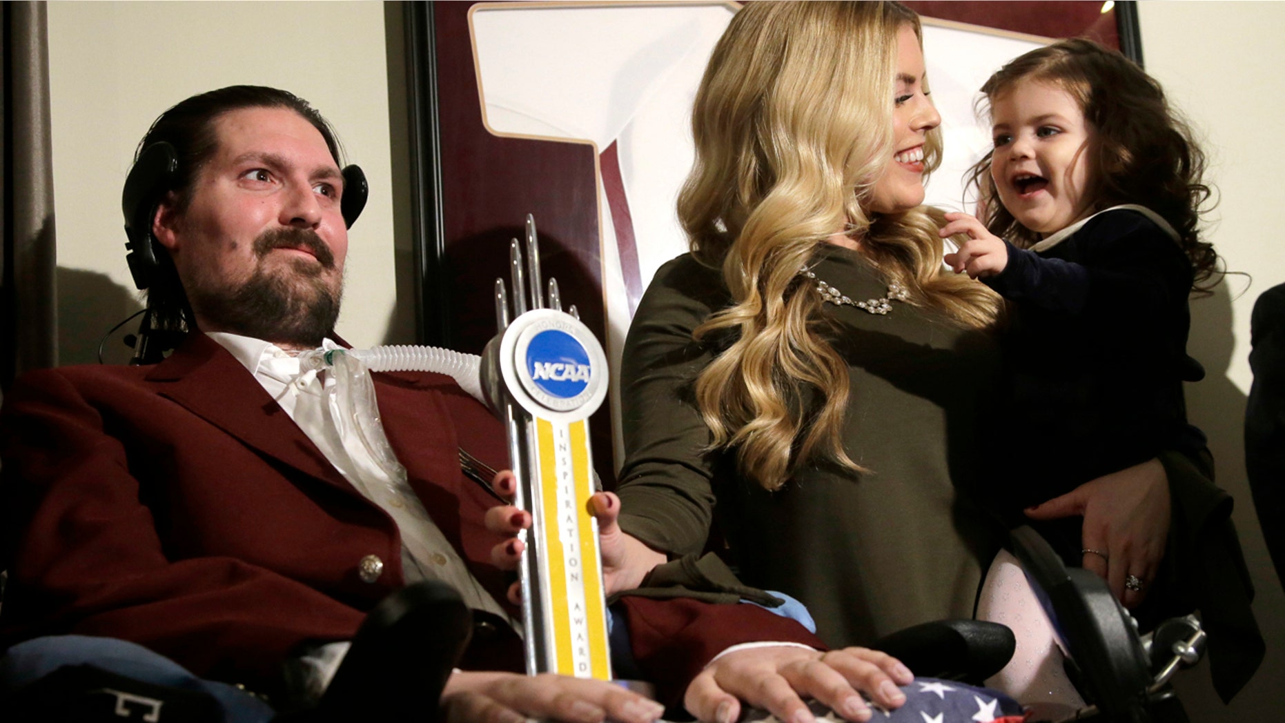 Dec. 13, 2016: In this file photo, former Boston College baseball captain Pete Frates, left, appears with his wife, Julie, center, and two-year-old daughter Lucy, right.