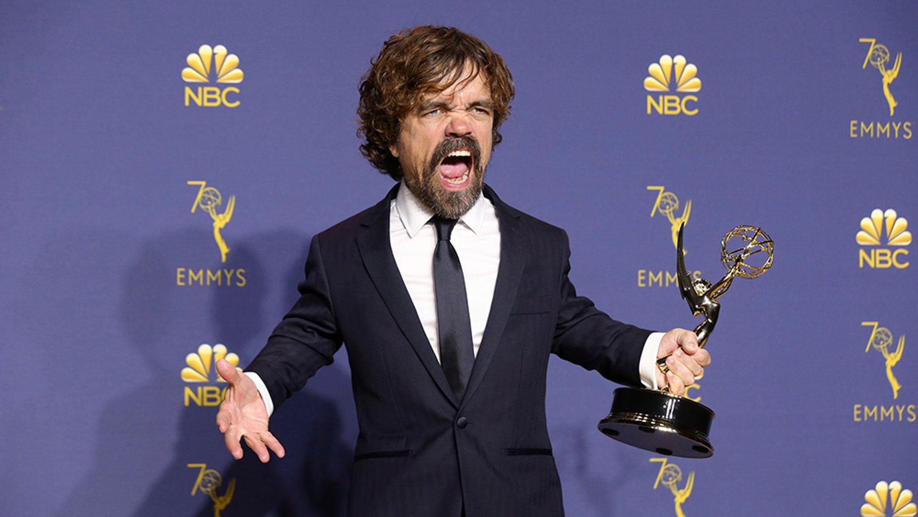 Peter Dinklage proudly holds his Emmy/
