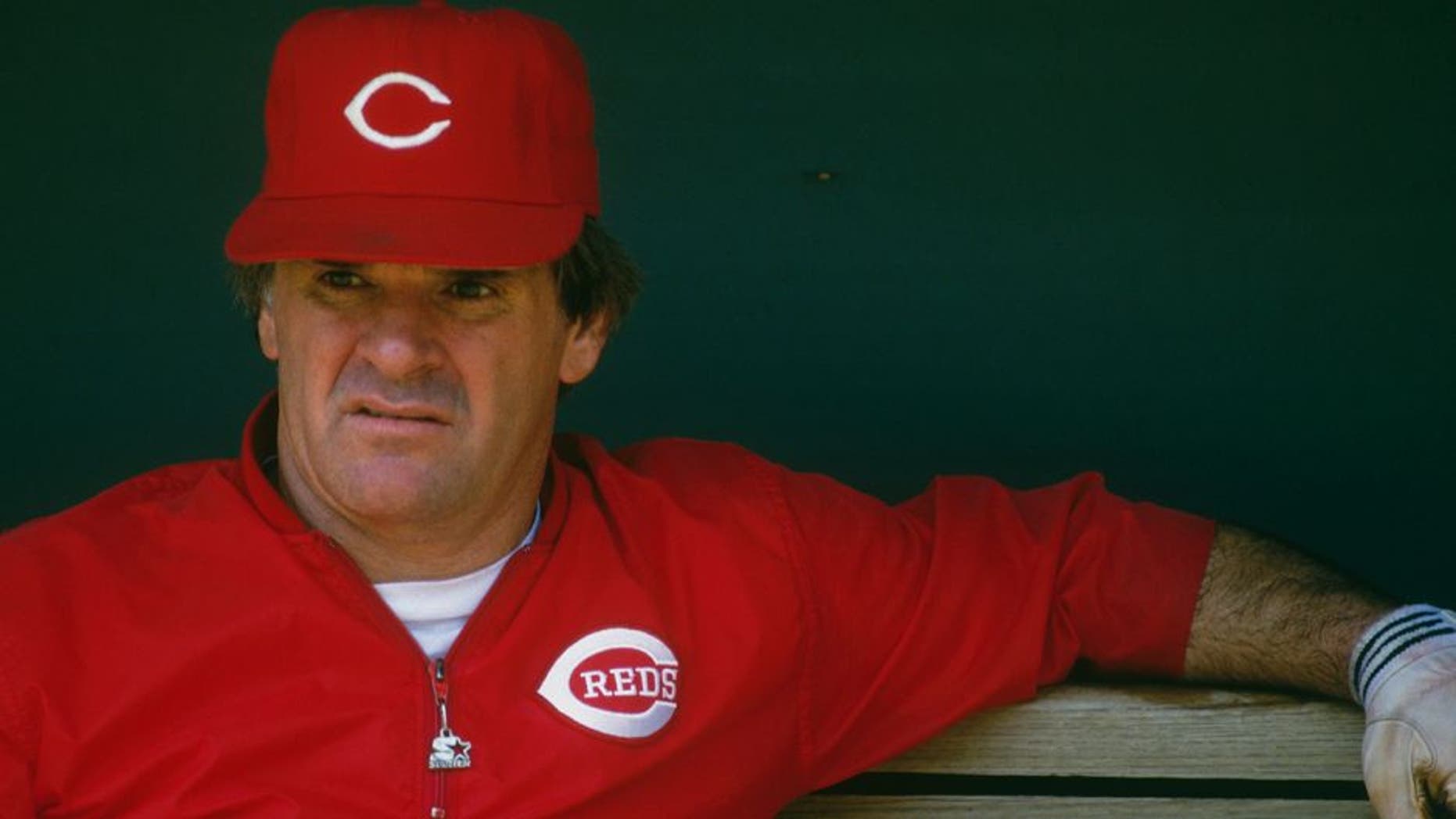 CINCINNATI - UNDATED: Pete Rose #14 of the Cincinnati Reds observes batting practice from the dugout at Riverfront Stadium during the 1980s in Cincinnati, Ohio. (Photo by Focus on Sport/Getty Images)