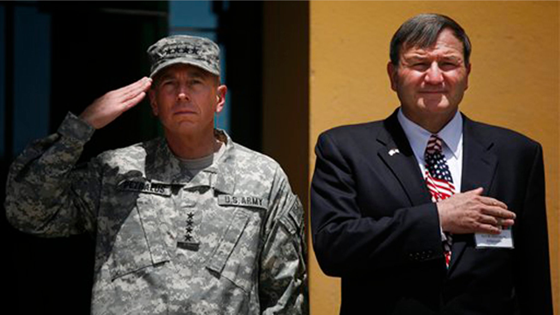 Gen. David Petraeus and U.S. Ambassador to Afghanistan Karl Eikenberry salute during the Independence Day celebrations July 3 in Kabul. (AP Photo)