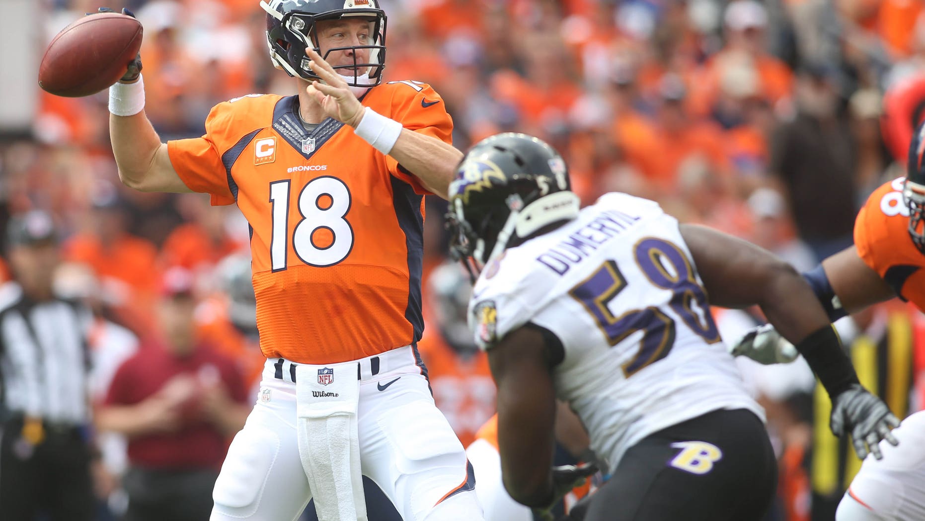 Sep 13, 2015; Denver, CO, USA; Denver Broncos quarterback Peyton Manning (18) throws the ball during the first half against the Baltimore Ravens at Sports Authority Field at Mile High. Mandatory Credit: Chris Humphreys-USA TODAY Sports